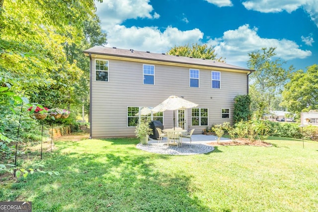 back of house featuring a yard and a patio