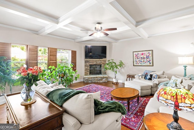 living room featuring beam ceiling, a stone fireplace, and coffered ceiling