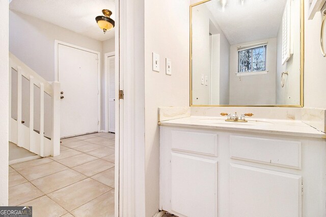 bathroom with tile patterned floors and vanity