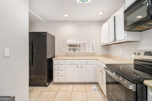 kitchen featuring black appliances, white cabinetry, and light tile patterned floors