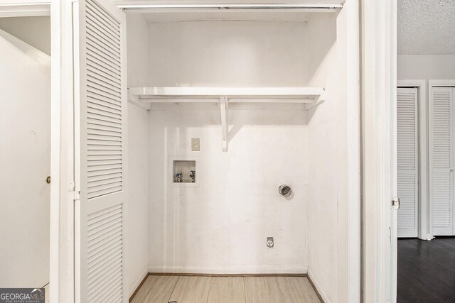 empty room with ornamental molding, dark wood-type flooring, and a textured ceiling