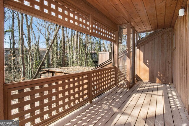 unfurnished bedroom featuring ceiling fan, ensuite bathroom, hardwood / wood-style floors, a textured ceiling, and ornamental molding