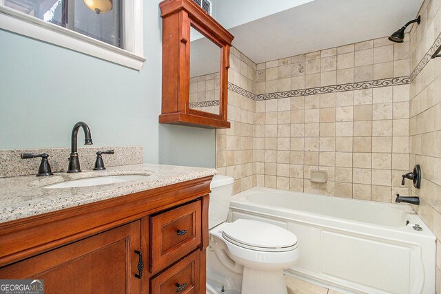 full bathroom featuring vanity, toilet, and tiled shower / bath combo