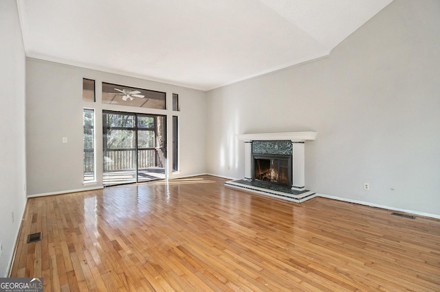 unfurnished living room with ceiling fan, light hardwood / wood-style floors, and crown molding