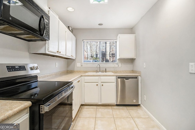 kitchen with sink, white cabinetry, stainless steel appliances, and light tile patterned floors