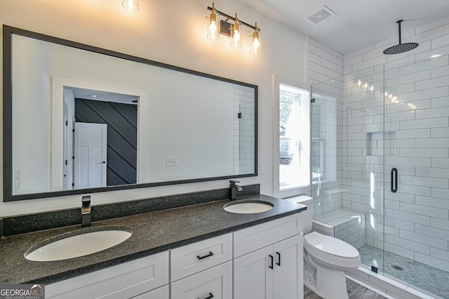 bathroom with vanity, toilet, and an enclosed shower