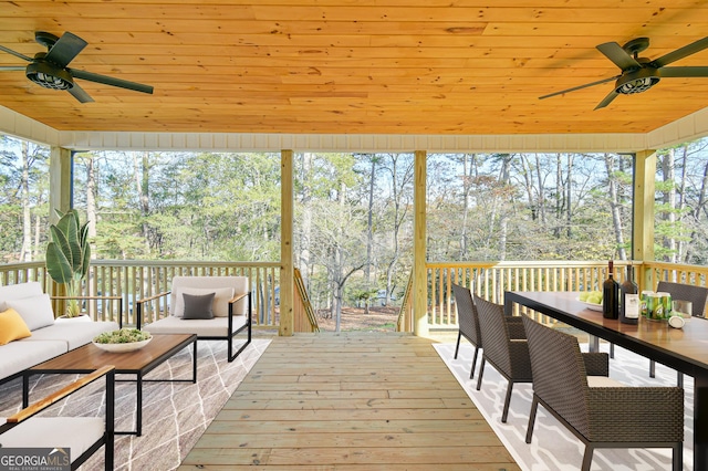 deck with outdoor lounge area and ceiling fan