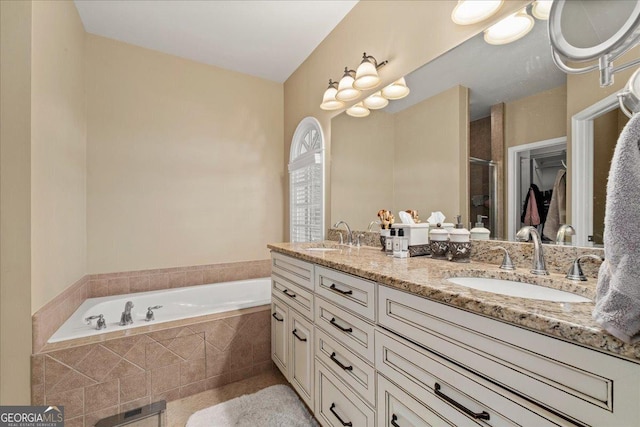 bathroom with vanity and shower with separate bathtub