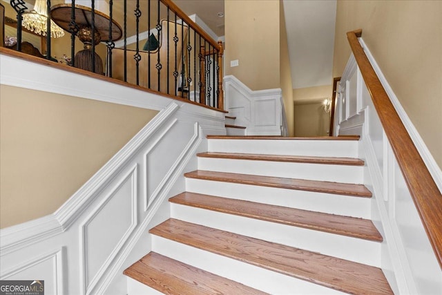 stairway featuring a chandelier