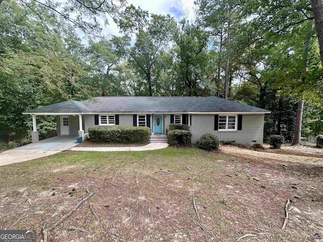 ranch-style home featuring a carport