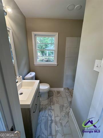 bathroom featuring vanity and toilet