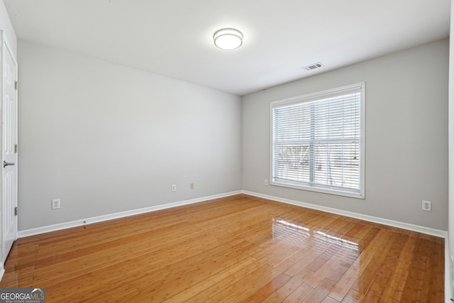 empty room with hardwood / wood-style floors