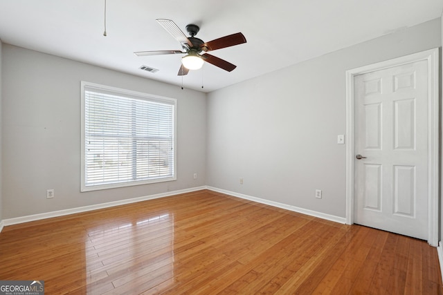 empty room featuring light hardwood / wood-style floors, a wealth of natural light, and ceiling fan