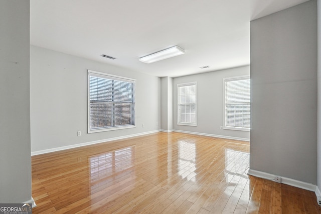 empty room with a healthy amount of sunlight and light wood-type flooring