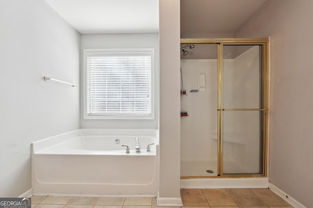 bathroom with tile patterned floors and separate shower and tub