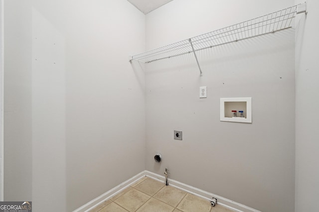 laundry area featuring electric dryer hookup, gas dryer hookup, hookup for a washing machine, and light tile patterned floors