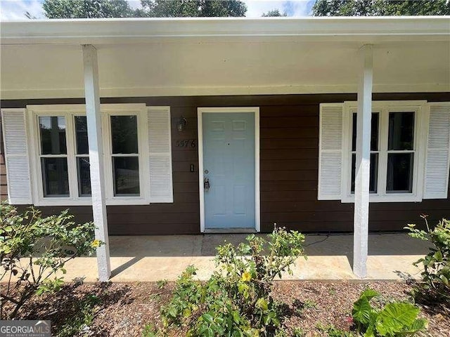 doorway to property featuring a porch