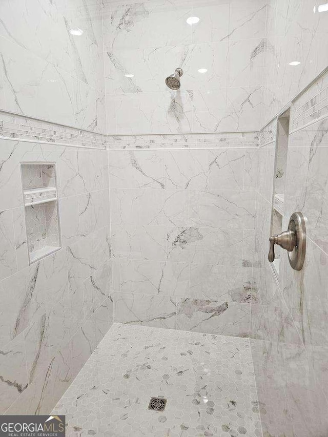 bathroom with a tile shower