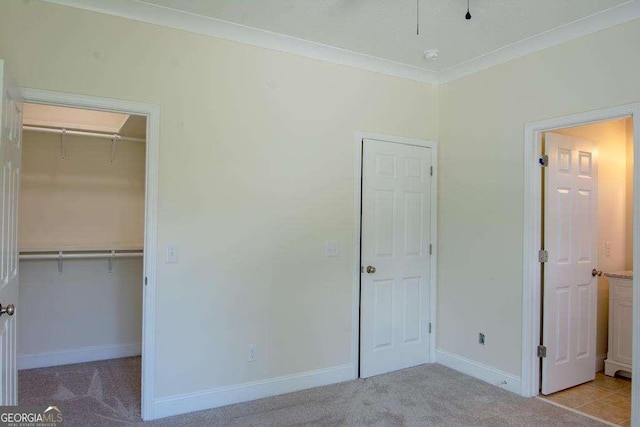 unfurnished bedroom with light carpet, a closet, and ornamental molding