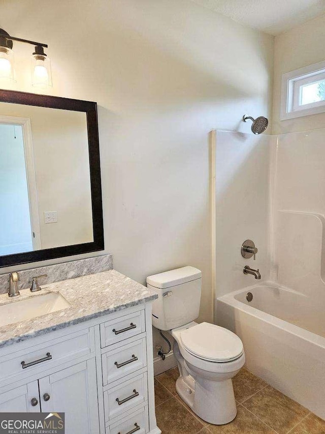 full bathroom featuring tile patterned flooring, vanity,  shower combination, and toilet