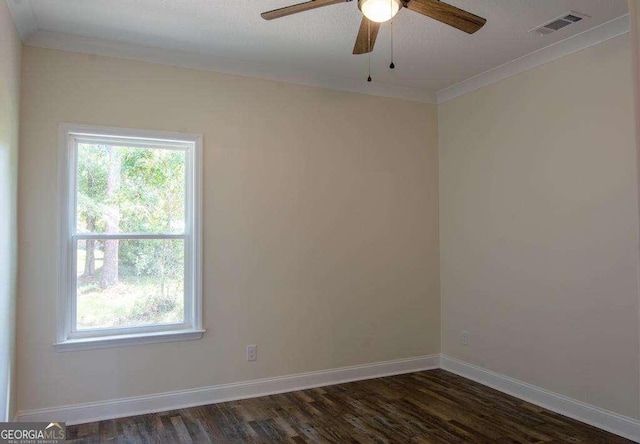 empty room featuring ceiling fan, dark hardwood / wood-style flooring, and crown molding