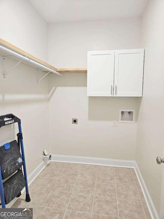 laundry area with electric dryer hookup, hookup for a washing machine, and cabinets