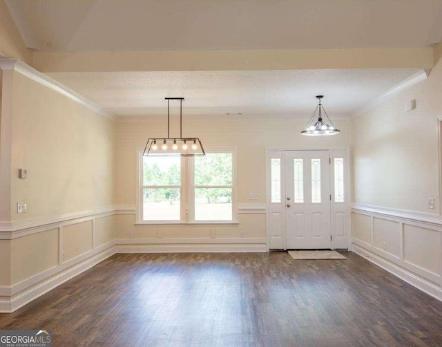 empty room featuring dark hardwood / wood-style floors and ornamental molding