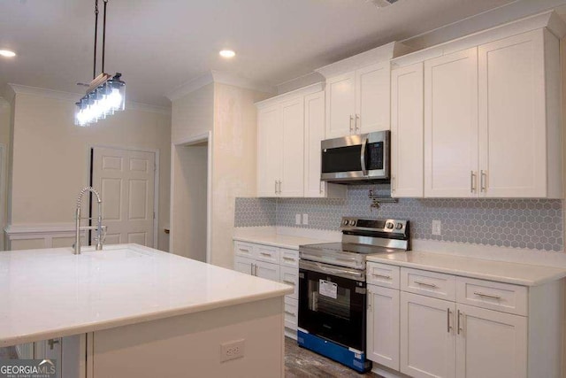 kitchen featuring a center island with sink, sink, white cabinetry, and stainless steel appliances