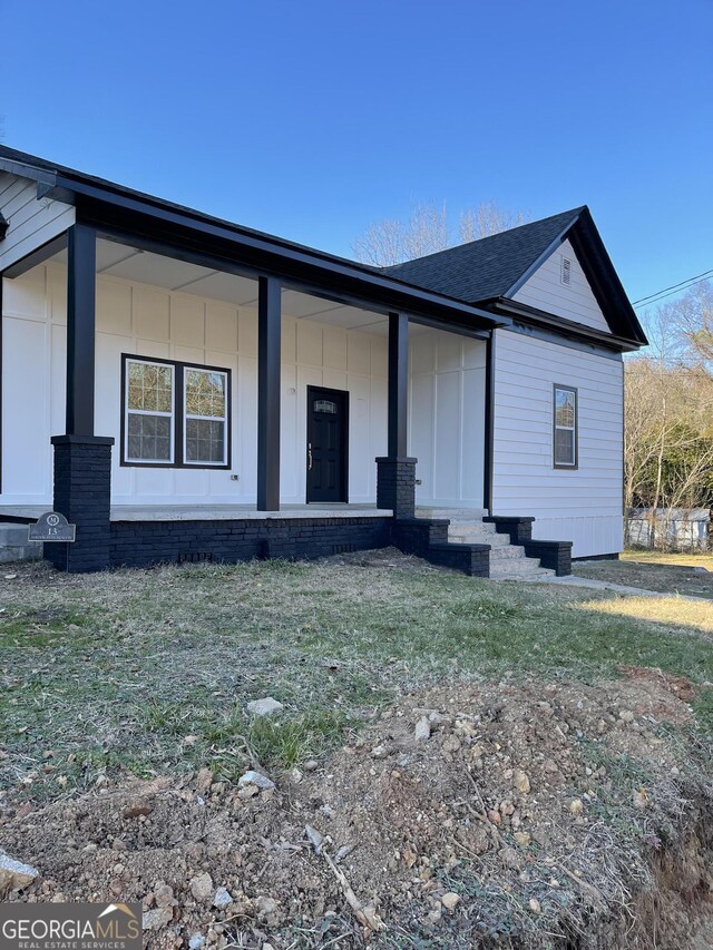 exterior space featuring a porch and a front lawn