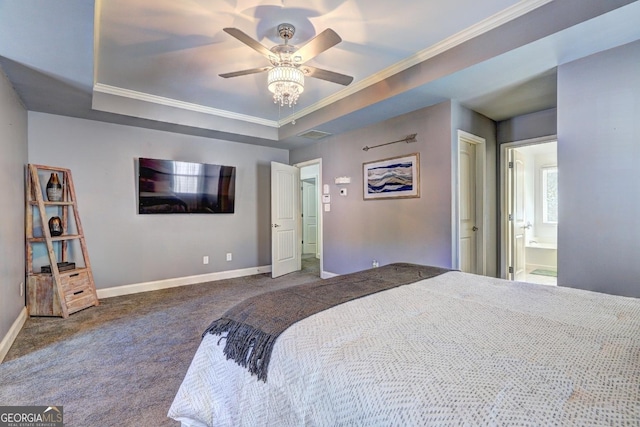 carpeted bedroom featuring ceiling fan, ensuite bathroom, baseboards, a raised ceiling, and crown molding