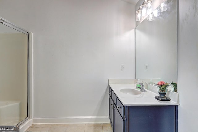 bathroom with tile patterned floors, baseboards, and vanity