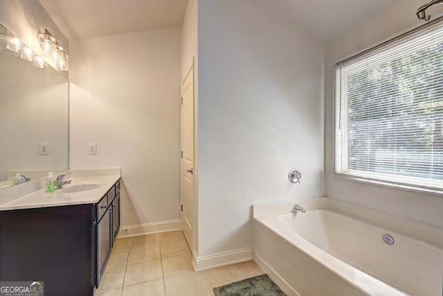 full bath with baseboards, tile patterned flooring, vaulted ceiling, vanity, and a bath