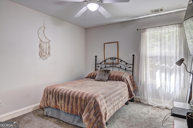 bedroom featuring a ceiling fan, carpet flooring, visible vents, and baseboards