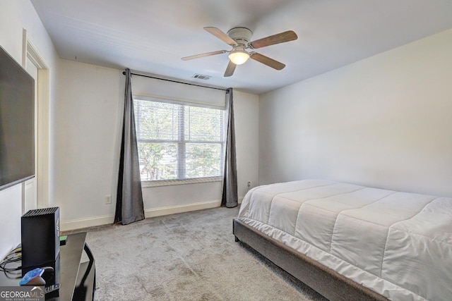 bedroom with baseboards, visible vents, a ceiling fan, and light colored carpet