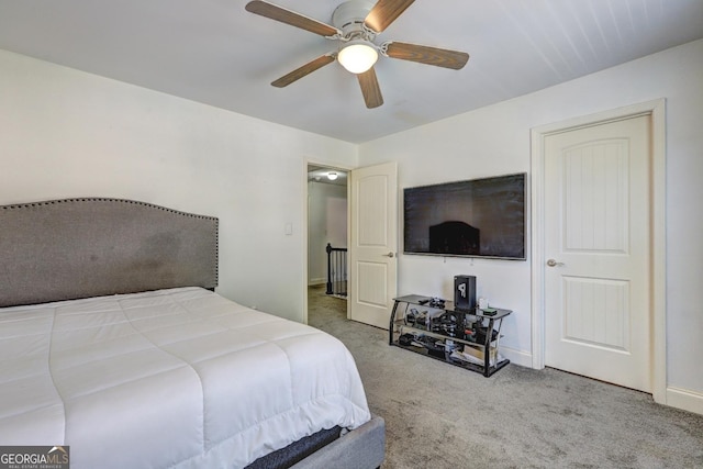 carpeted bedroom featuring ceiling fan and baseboards