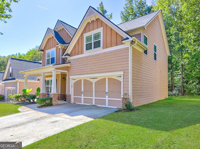 craftsman house with concrete driveway, covered porch, board and batten siding, a front yard, and a garage