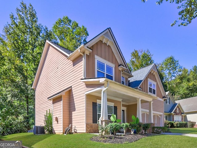 craftsman-style home featuring board and batten siding, central AC, a porch, and a front lawn