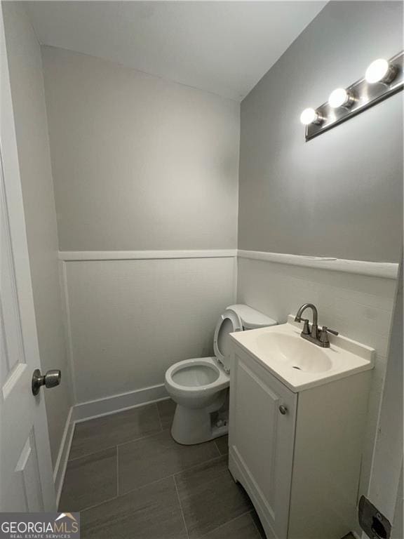 bathroom featuring vanity and toilet