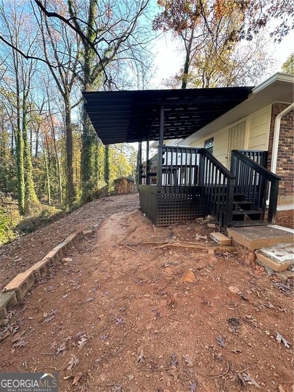 view of side of home featuring a wooden deck