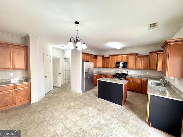 kitchen featuring a center island, crown molding, sink, decorative light fixtures, and stainless steel appliances