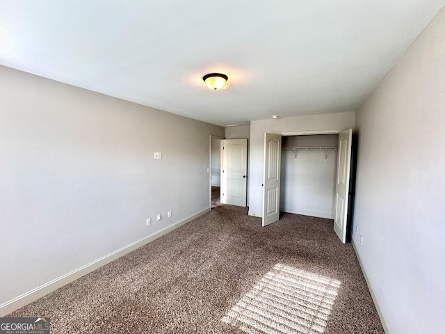 unfurnished bedroom featuring carpet and a closet