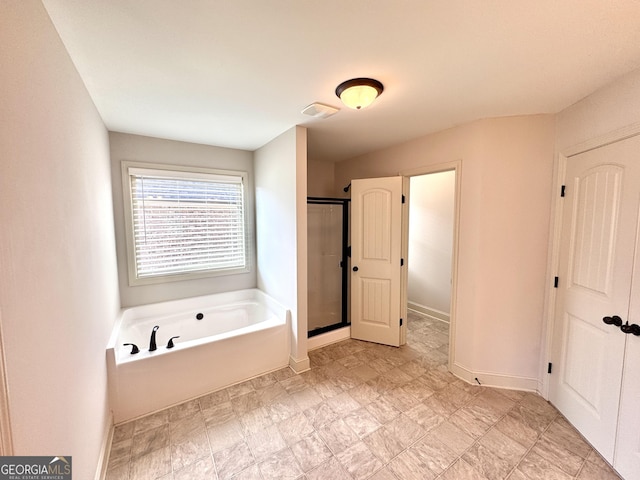 bathroom featuring independent shower and bath