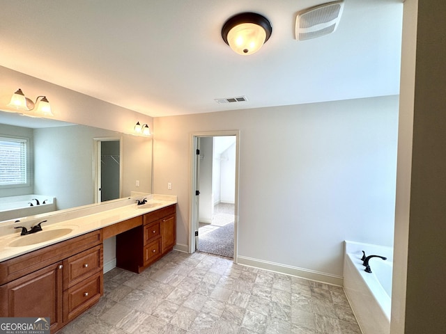 bathroom featuring a tub and vanity