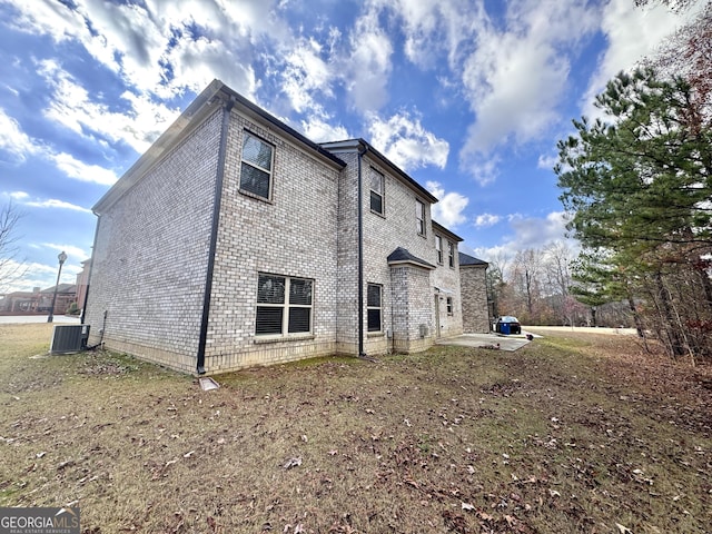 back of house with a patio and central AC