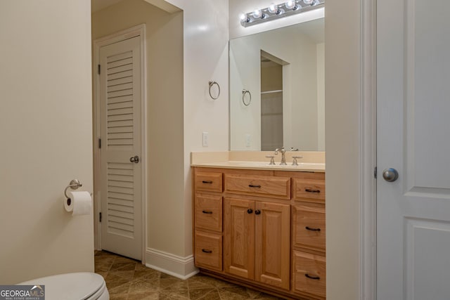 bathroom featuring tile patterned floors, vanity, and toilet