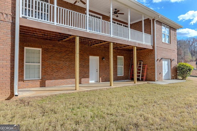 rear view of property featuring ceiling fan, a yard, and a deck