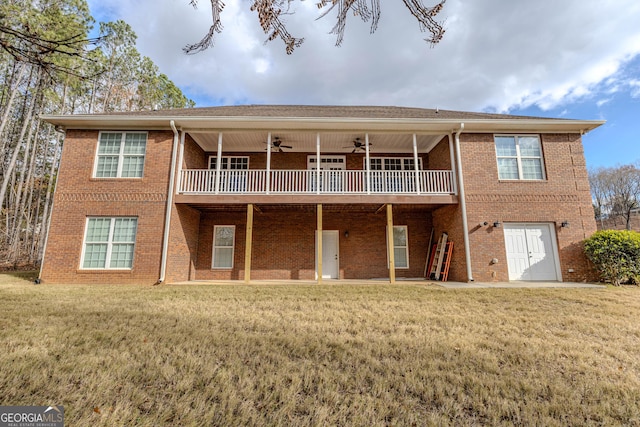 back of house with ceiling fan, a balcony, and a yard