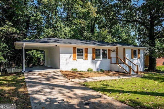 ranch-style home featuring a carport and a front yard