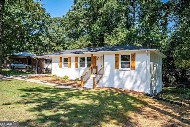 ranch-style home featuring a front yard