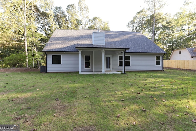 back of house featuring a patio and a lawn